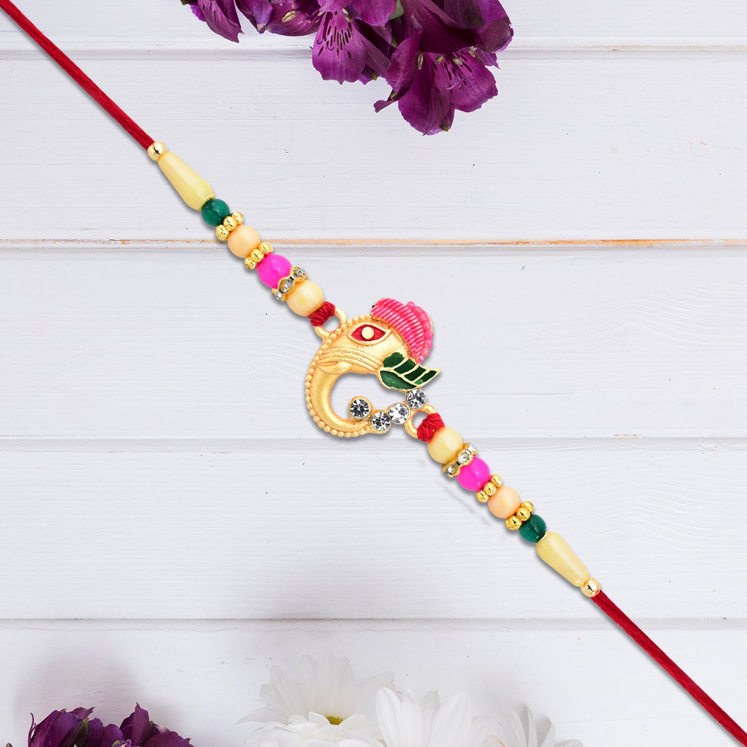 Stylish Ganesh Design Rakhi With Multicolor Beads And Gold Finish Accents Stylish Ganesh Design Rakhi With Multicolor Beads And Gold Finish Accents